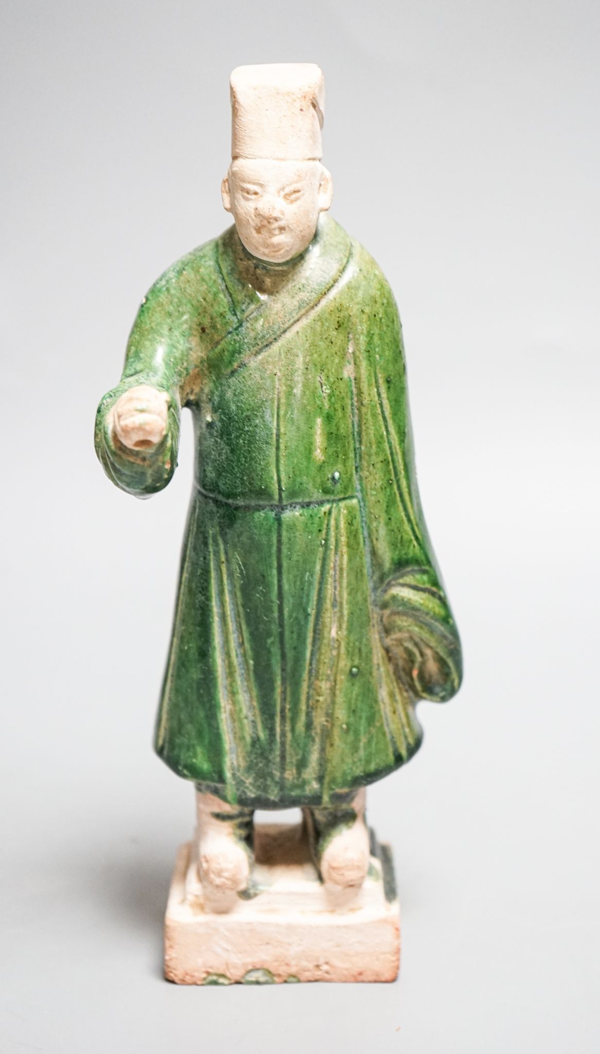 A Chinese Ming green glazed figure of an official 23cm